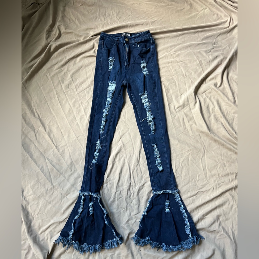 Tight jeans with a flare at the end & rips